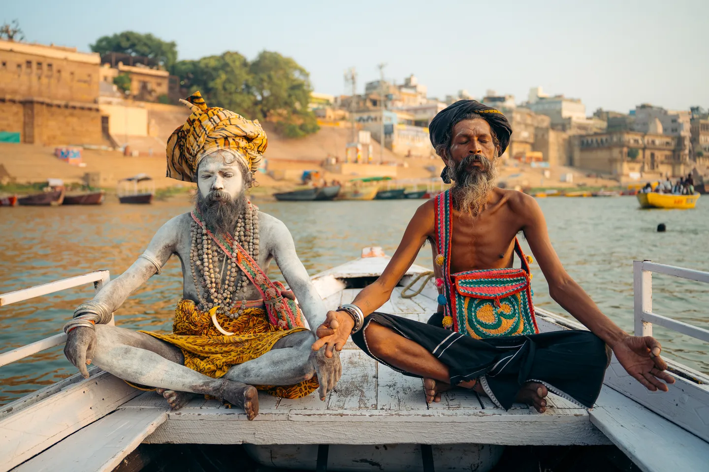 Two sadhus sitting on a boat on the Ganges in Varanasi